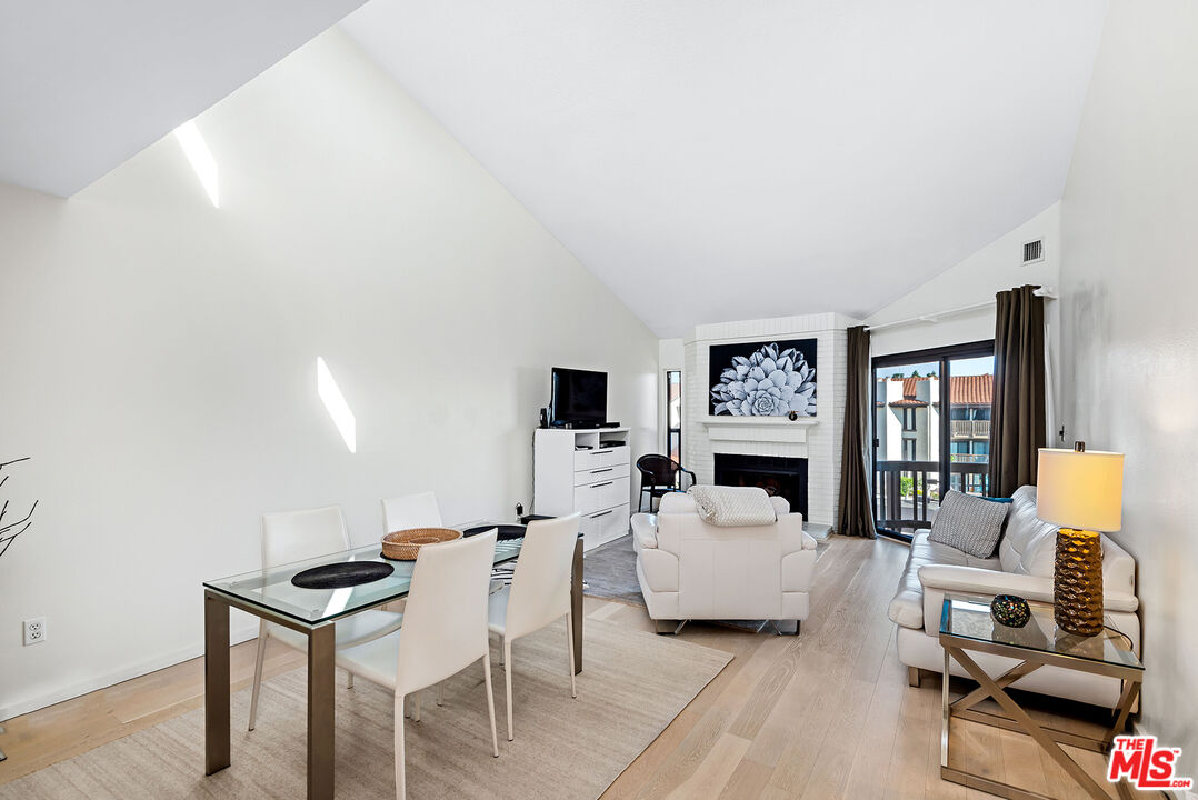 8600 Tuscany Avenue, Unit 419 Playa del Rey, CA 90293 - Photo 6 of 35 a living room with furniture a fireplace and a flat screen tv