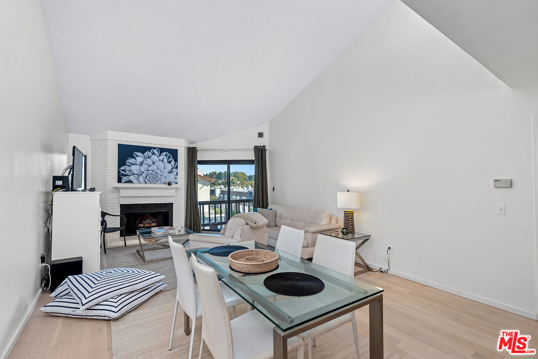 8600 Tuscany Avenue, Unit 419 Playa del Rey, CA 90293 - Photo 7 of 35 a living room with furniture and a fireplace