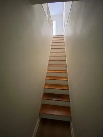 a room with wooden floor and windows