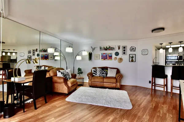 a living room with furniture and wooden floor