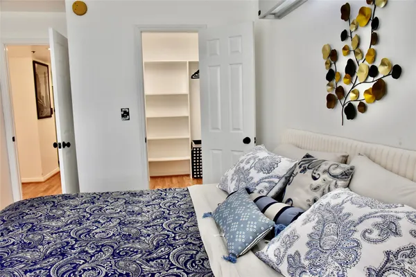 a bedroom with a bed and cabinets