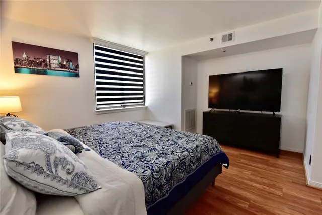a bedroom with a bed and a flat screen tv