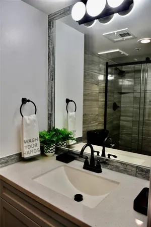a bathroom with a sink and a mirror