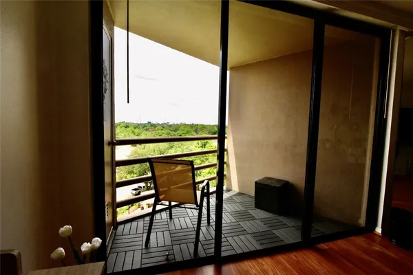 a view of a porch with furniture and wooden floor