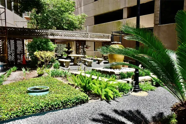 a view of a patio with table and chairs potted plants