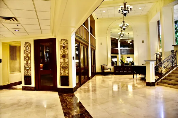 a living room with patio furniture and a potted plant