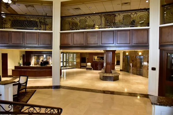 a view of a patio with table and chairs potted plants and large tree