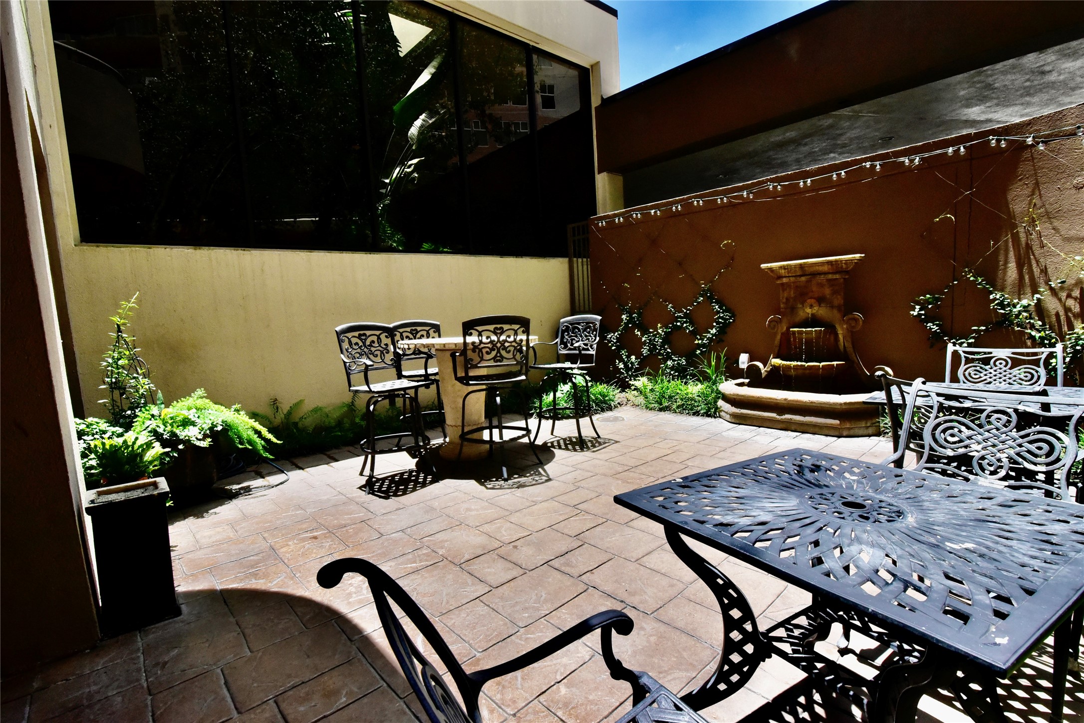 3525 Sage Road, Unit 701 Houston, TX 77056 - Photo 46 of 48 a view of a patio with table and chairs potted plants with wooden floor