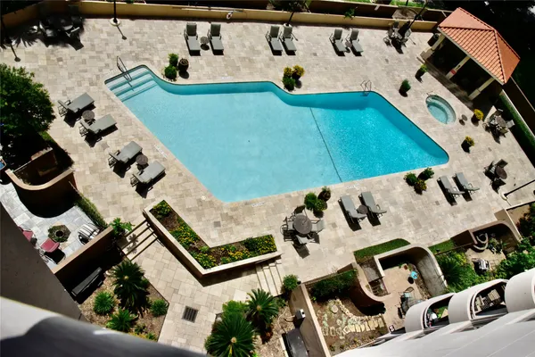 a view of a patio with chairs and plants