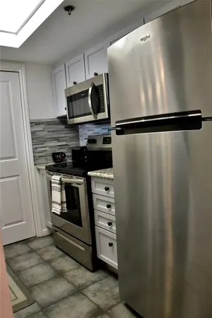 a kitchen with appliances and cabinets