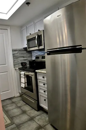 a kitchen with appliances and cabinets