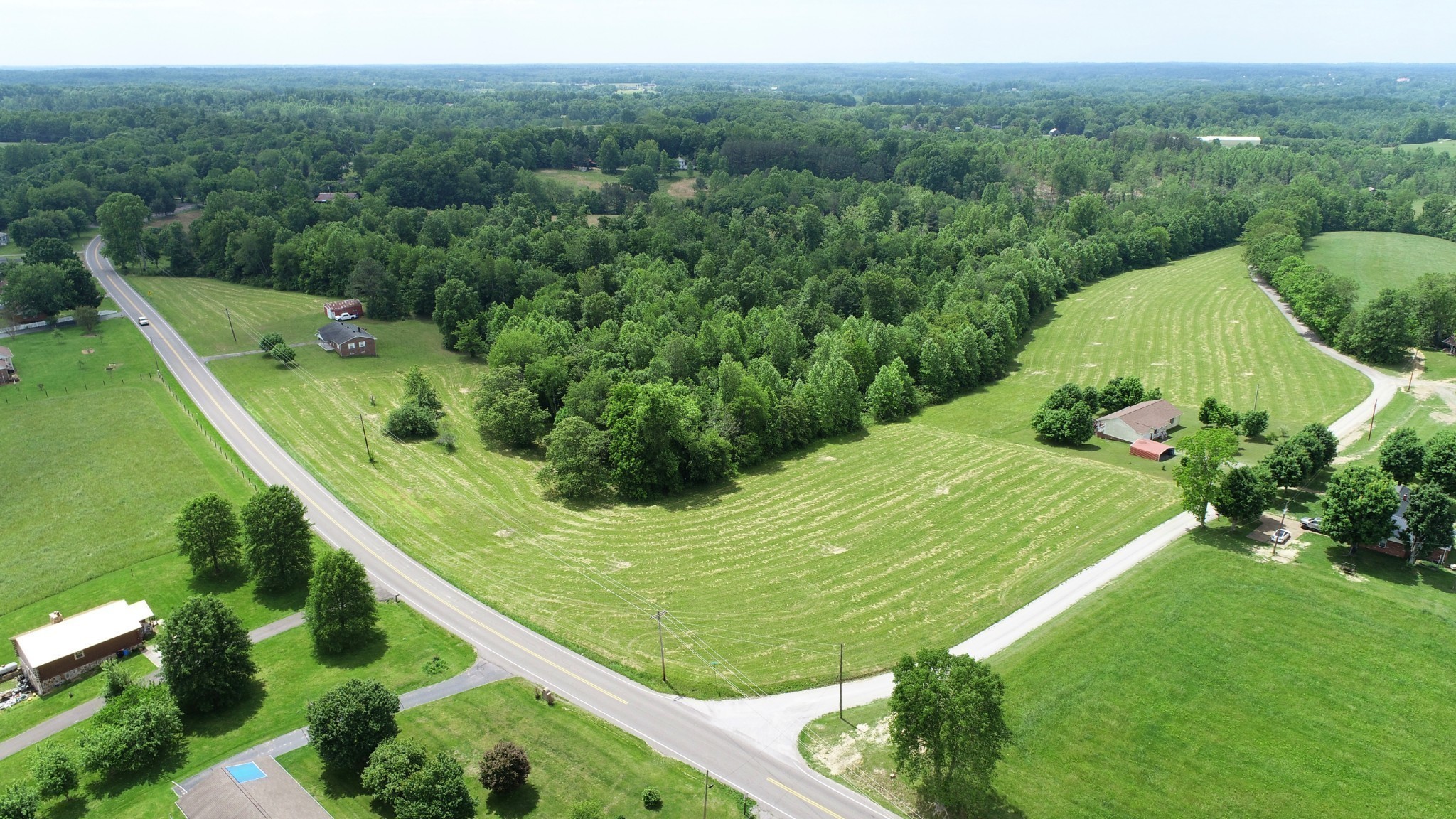 7 Whitson Hollow Road Red Boiling Springs, TN 37150 - Photo 2 of 5 a view of a garden with a building in the background
