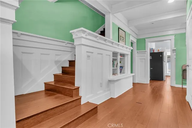 a bedroom with a bed and large windows