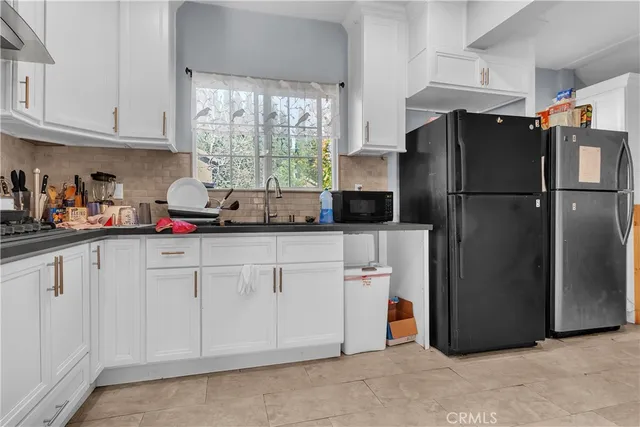 a utility room with sink dryer and washer