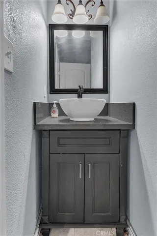 a bathroom with a sink a toilet and a mirror