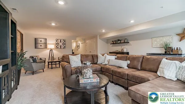 a living room with furniture wooden floor and a flat screen tv