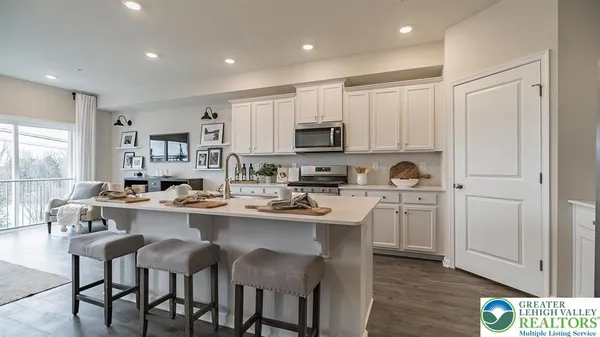 a kitchen with appliances a sink and cabinets
