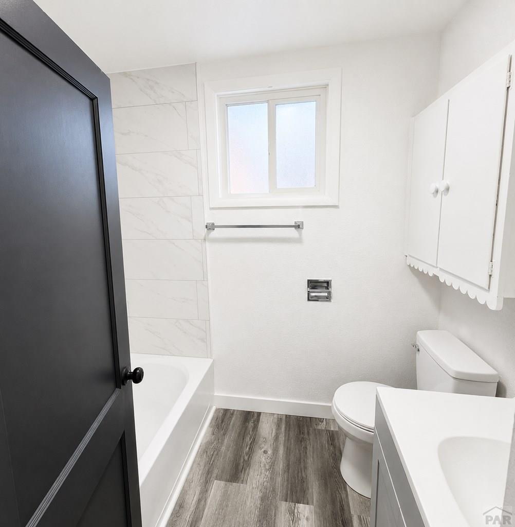 207 Spring Street Pueblo, CO 81003 - Photo 6 of 11 a bathroom with a toilet a sink and a bathtub