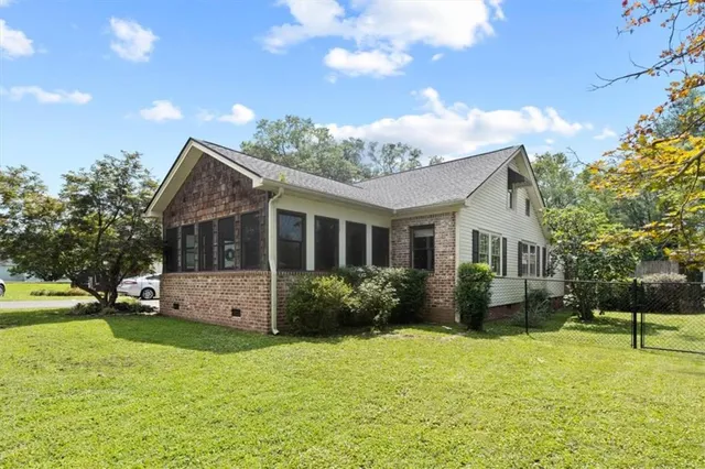 a view of a house with a yard and potted plants