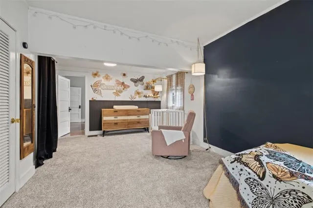 a bed room with a bed and a chair