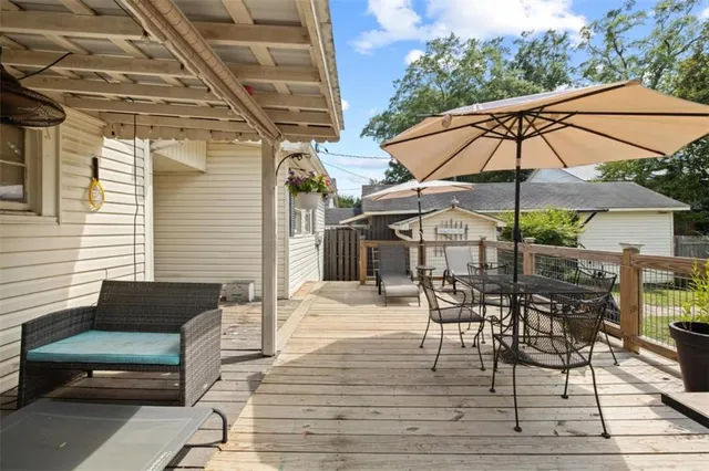 a view of a patio with a table and chairs under an umbrella