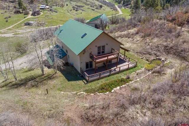 an aerial view of a house with a yard
