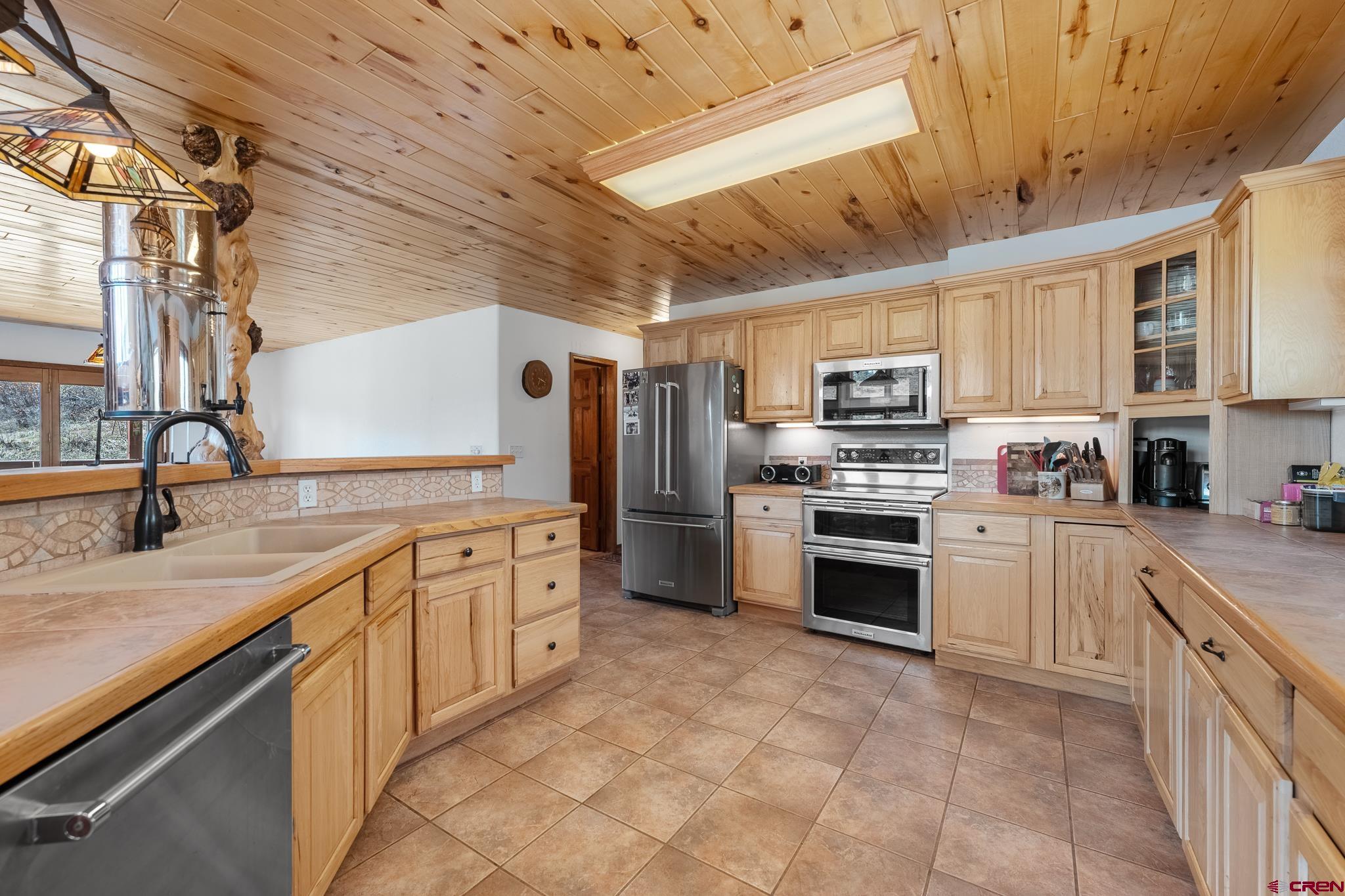26 Severn Peak Road Bayfield, CO 81122 - Photo 12 of 36 a kitchen with stainless steel appliances granite countertop a stove sink and cabinets