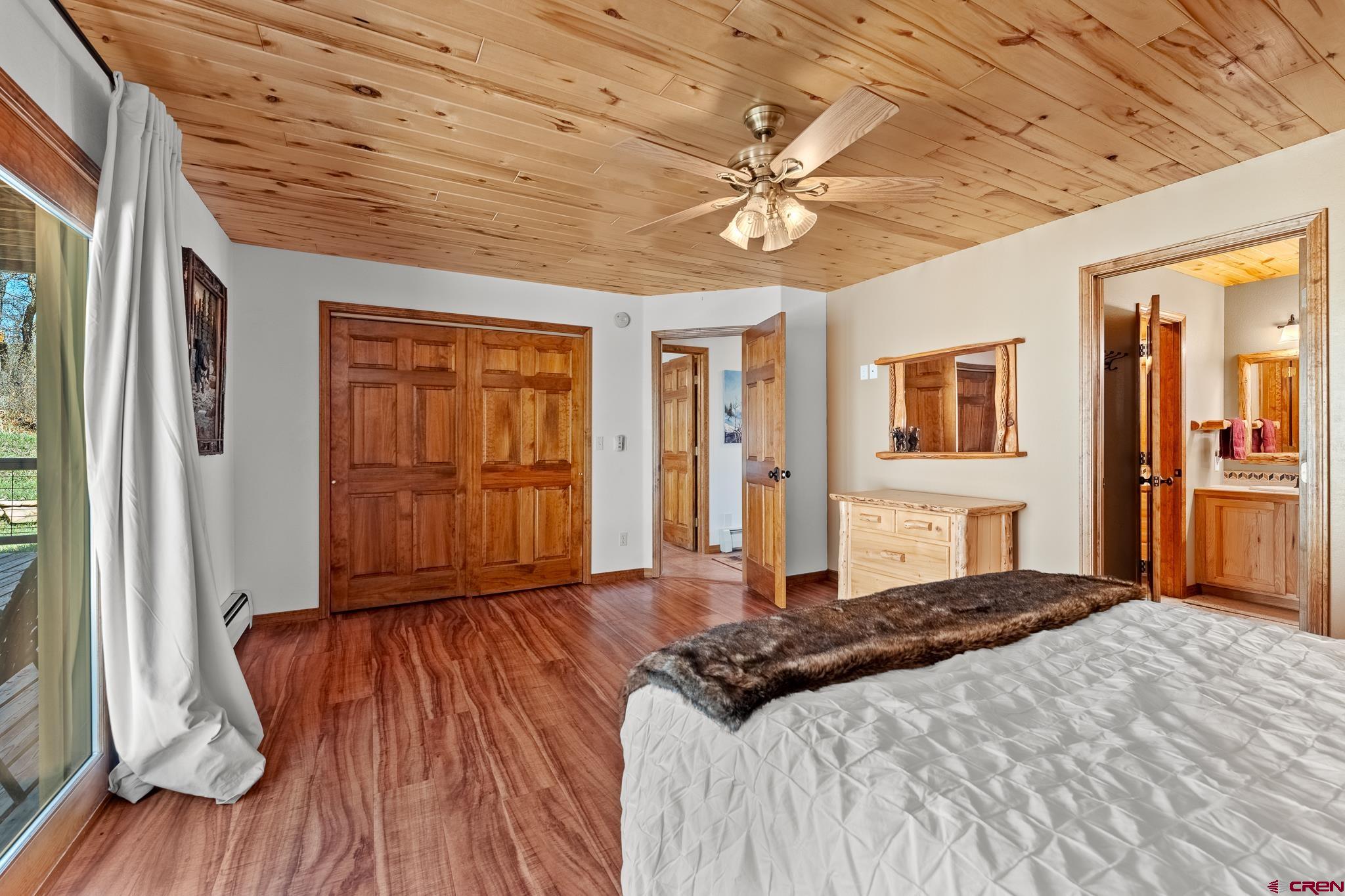 26 Severn Peak Road Bayfield, CO 81122 - Photo 23 of 36 a bedroom with a large bed and a chandelier