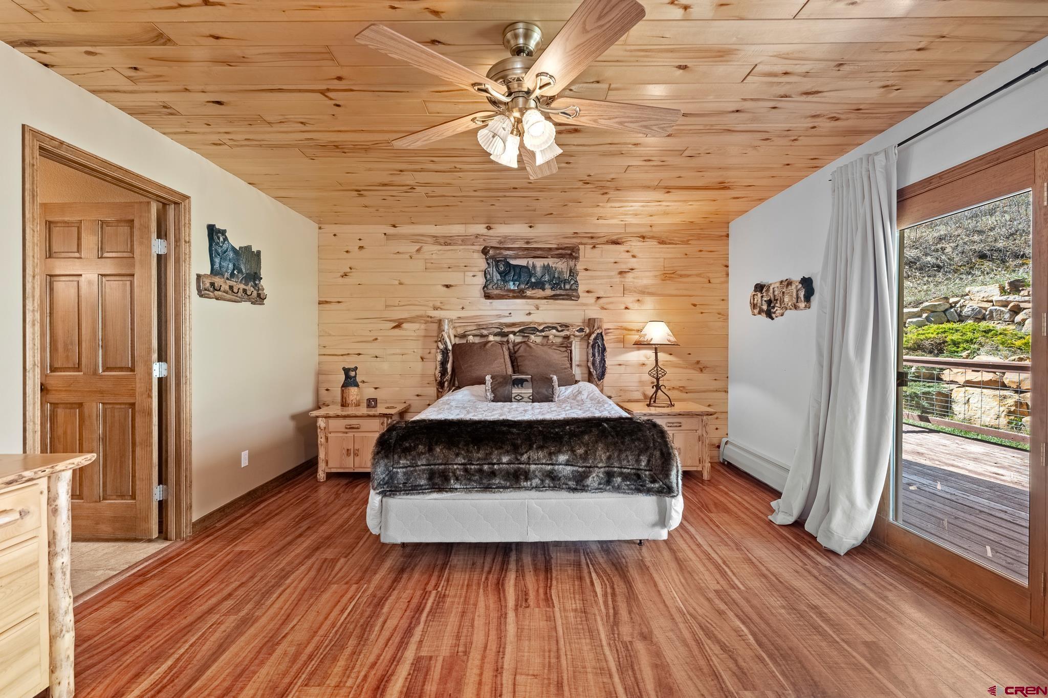 26 Severn Peak Road Bayfield, CO 81122 - Photo 24 of 36 a bedroom with a bed and wooden floor