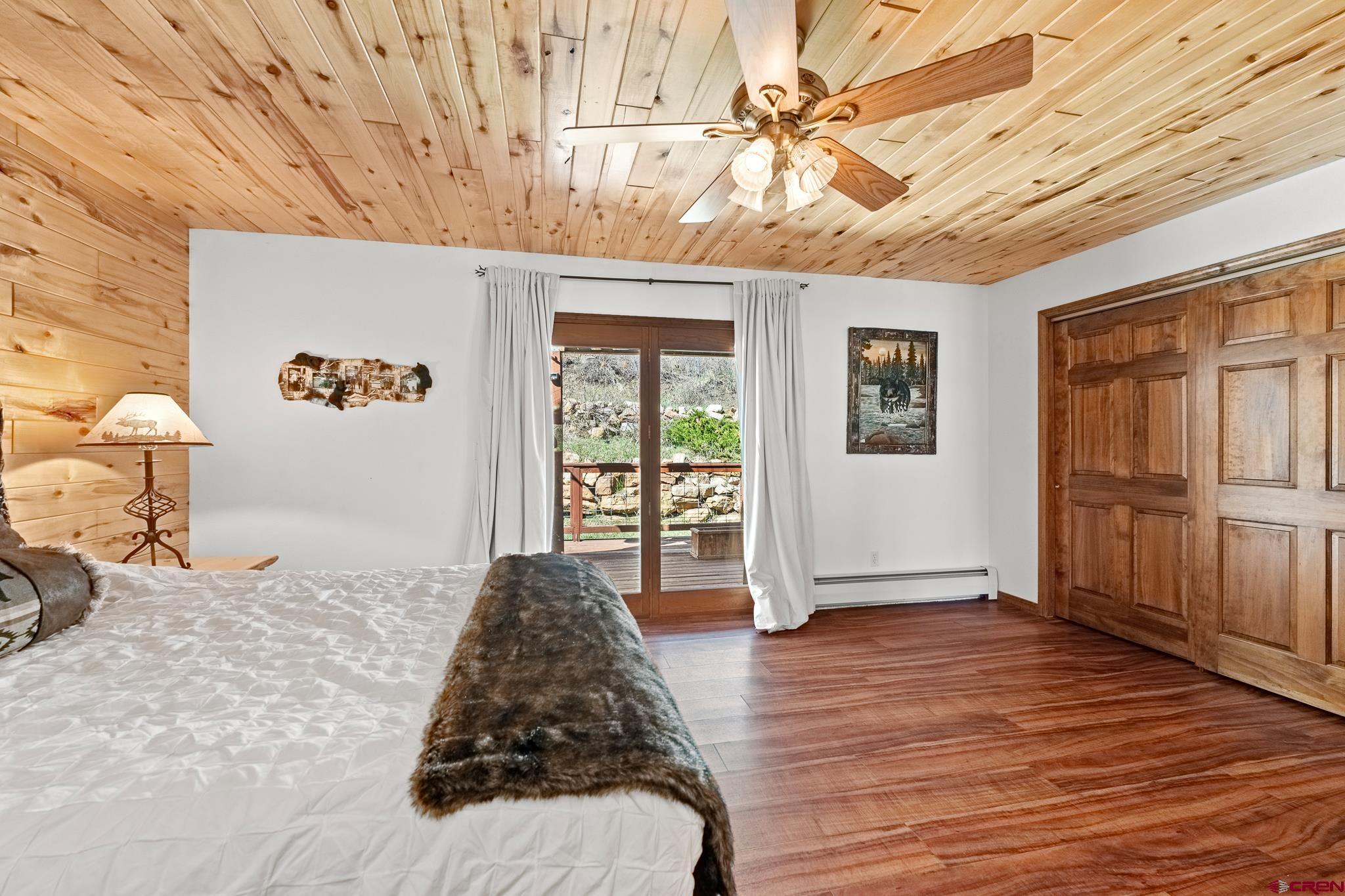 26 Severn Peak Road Bayfield, CO 81122 - Photo 25 of 36 a bedroom with a bed and wooden floor