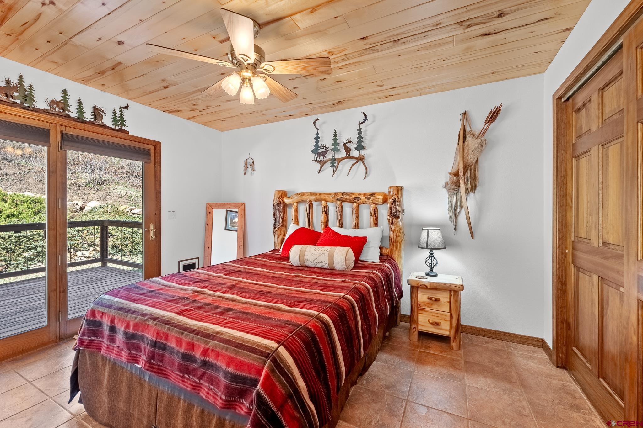 26 Severn Peak Road Bayfield, CO 81122 - Photo 26 of 36 a bedroom with a bed and a large window with the outer view
