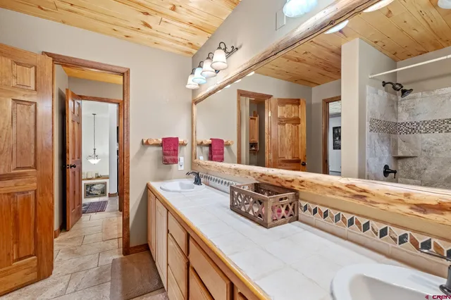 a bathroom with a double vanity sink mirror and