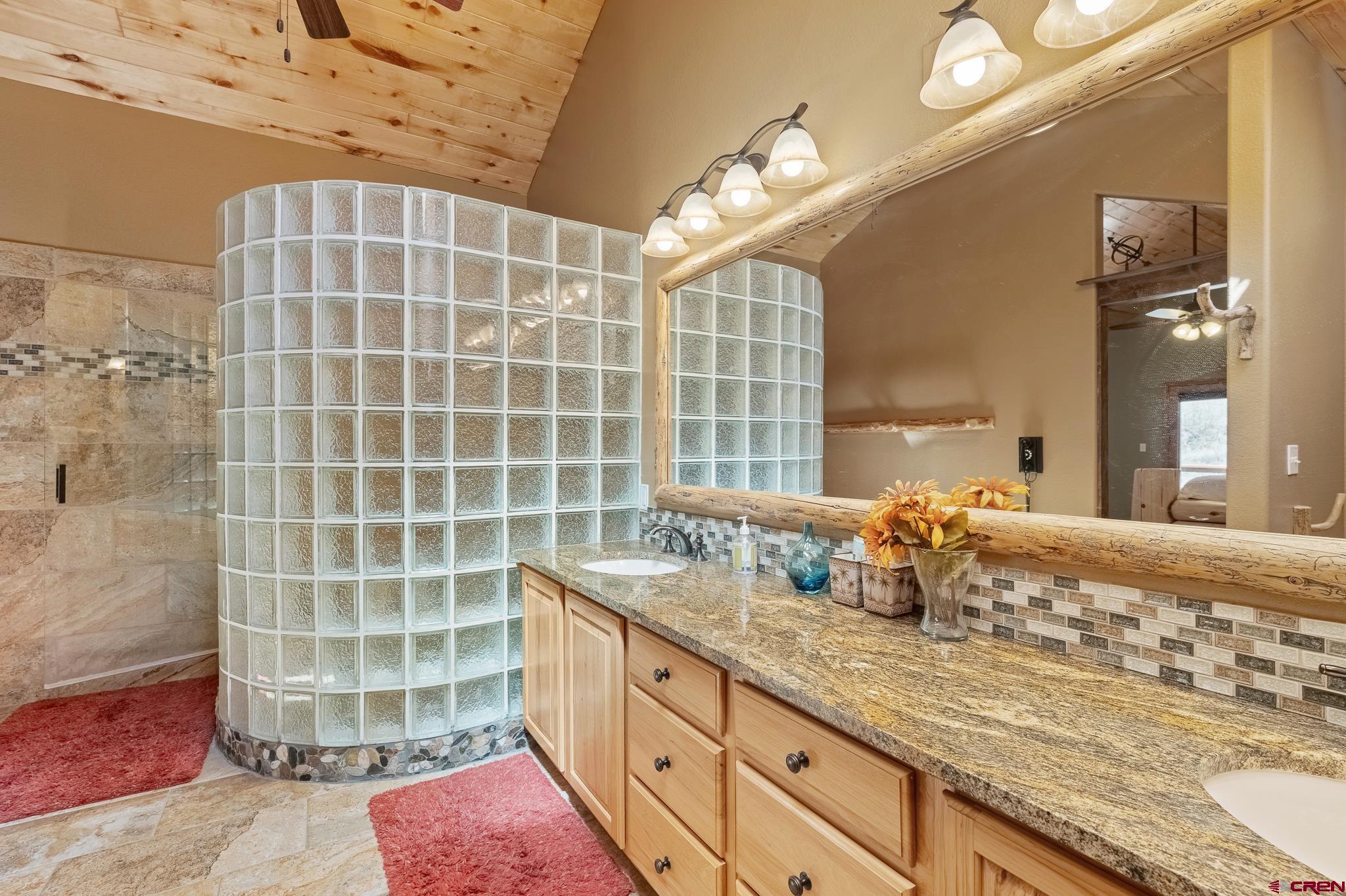 26 Severn Peak Road Bayfield, CO 81122 - Photo 29 of 36 a bathroom with a double vanity sink mirror and