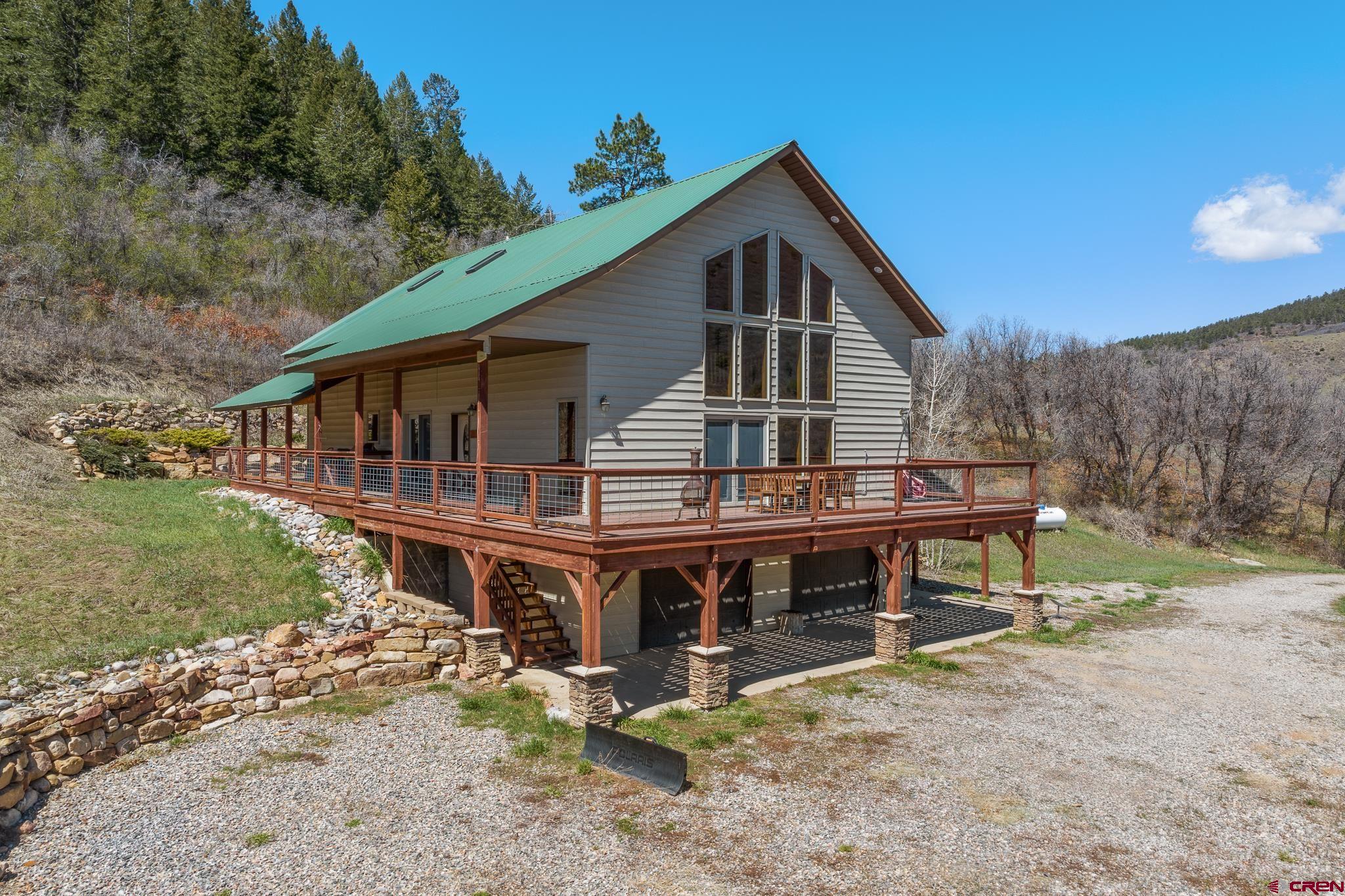 26 Severn Peak Road Bayfield, CO 81122 - Photo 33 of 36 a view of a house with wooden deck and furniture