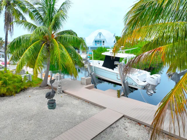 an aerial view of residential houses with outdoor space and swimming pool