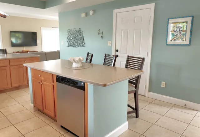an aerial view of residential houses with outdoor space and lake view