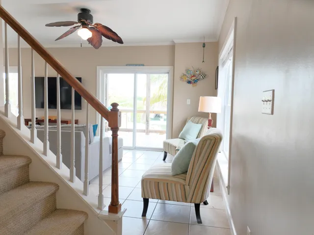 a kitchen with stainless steel appliances a refrigerator a stove a sink a table and chairs