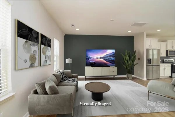 a living room with furniture and a flat screen tv