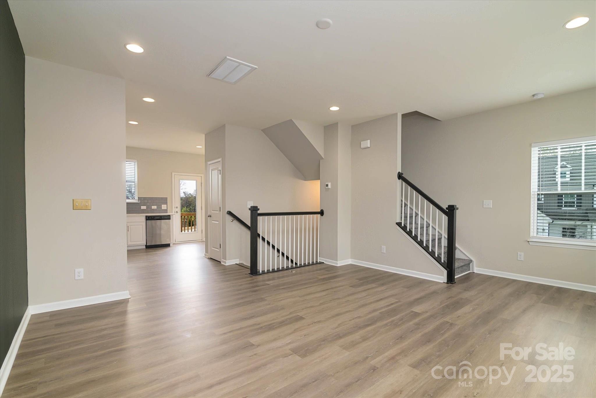 13304 Porter Creek Road Charlotte, NC 28262 - Photo 12 of 22 a view of empty room with wooden floor and windows