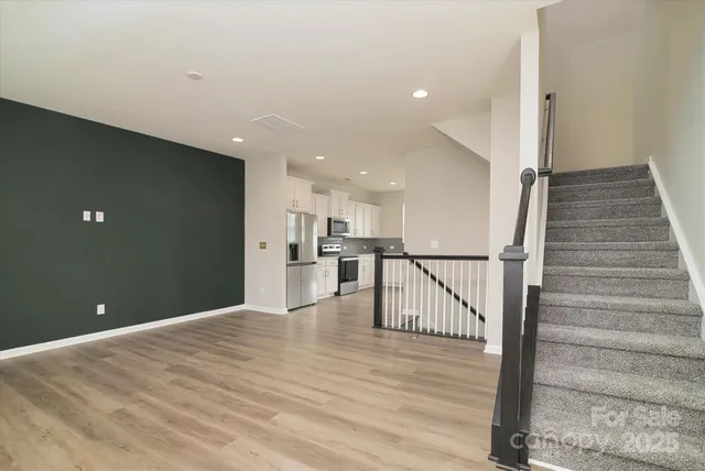 a kitchen with granite countertop a refrigerator stove and microwave