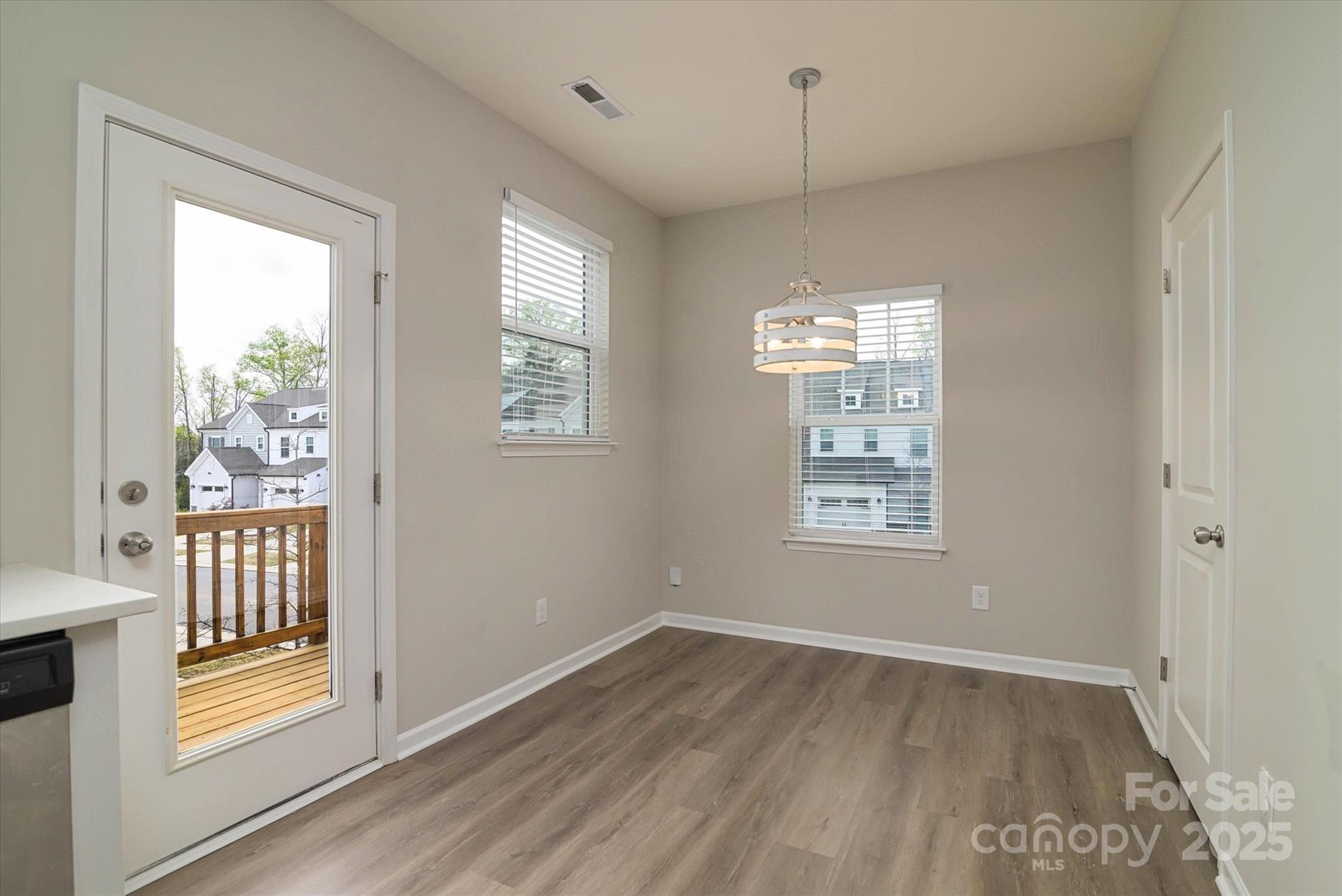 13304 Porter Creek Road Charlotte, NC 28262 - Photo 17 of 22 a view of an empty room with a window and wooden floor