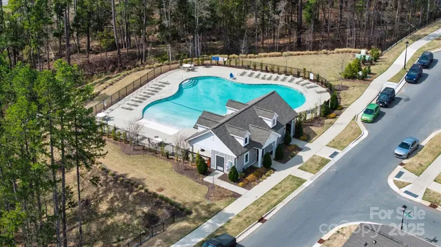 an aerial view of a house with a swimming pool
