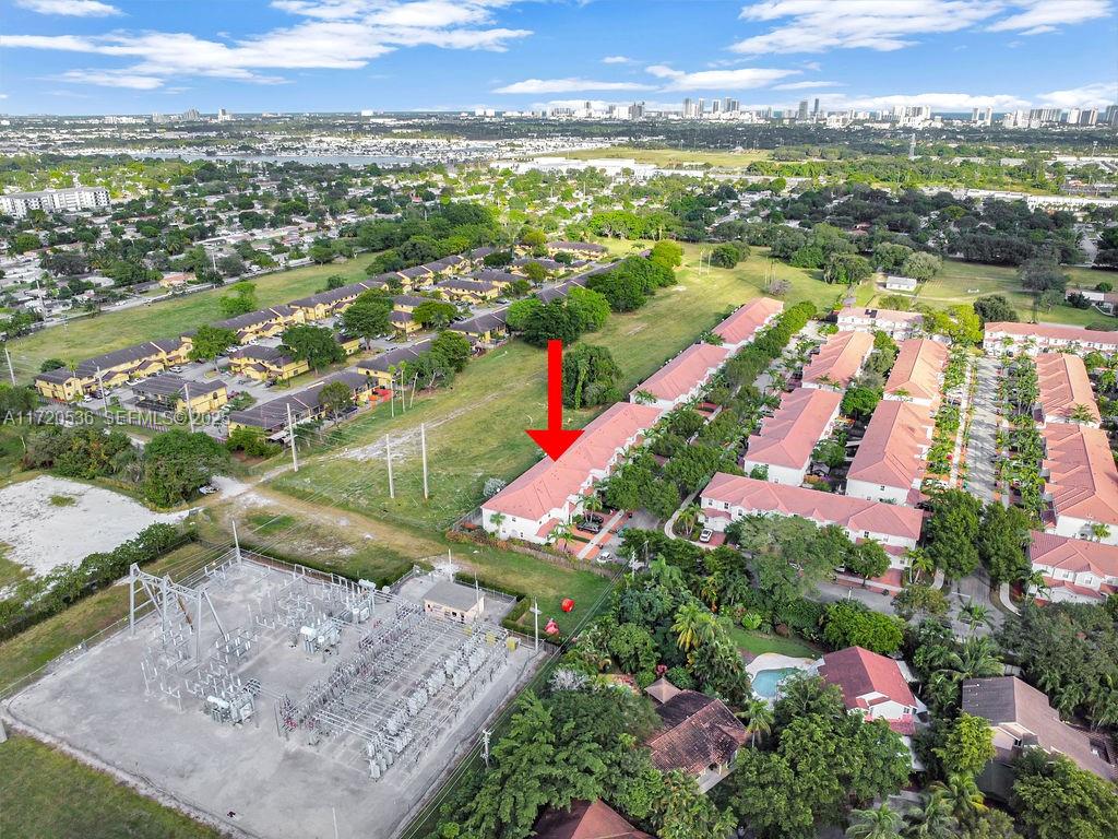 1007 Northeast 208th Street, Unit 1007 Miami, FL 33179 - Photo 14 of 68 an aerial view of residential houses with outdoor space and river
