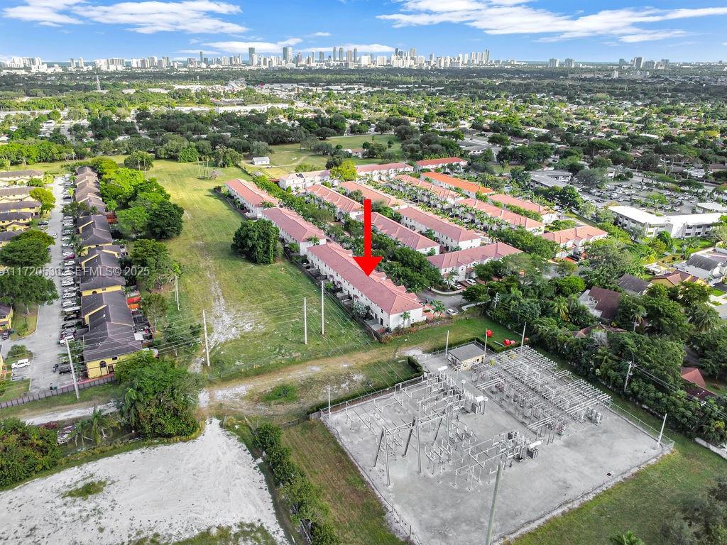 1007 Northeast 208th Street, Unit 1007 Miami, FL 33179 - Photo 16 of 68 an aerial view of residential houses with outdoor space and trees