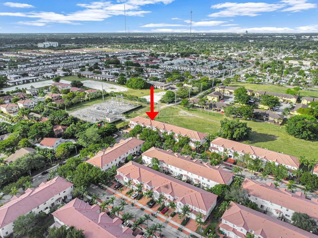 1007 Northeast 208th Street, Unit 1007 Miami, FL 33179 - Photo 21 of 68 an aerial view of residential houses with outdoor space