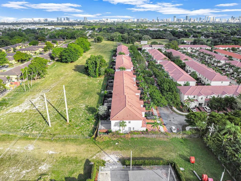 1007 Northeast 208th Street, Unit 1007 Miami, FL 33179 - Photo 22 of 68 an aerial view of residential houses with outdoor space and trees