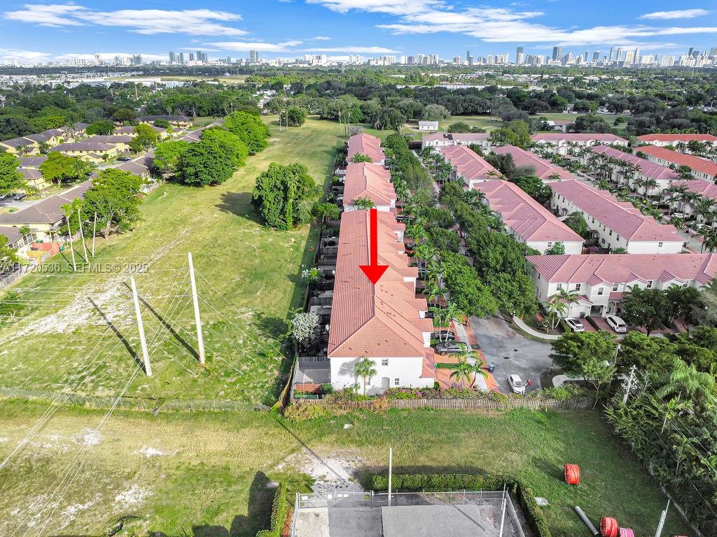 1007 Northeast 208th Street, Unit 1007 Miami, FL 33179 - Photo 23 of 68 an aerial view of residential houses with outdoor space and swimming pool