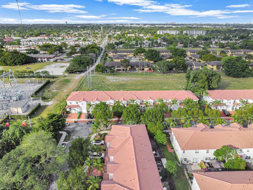 1007 Northeast 208th Street, Unit 1007 Miami, FL 33179 - Photo 26 of 68 an aerial view of a house with a garden