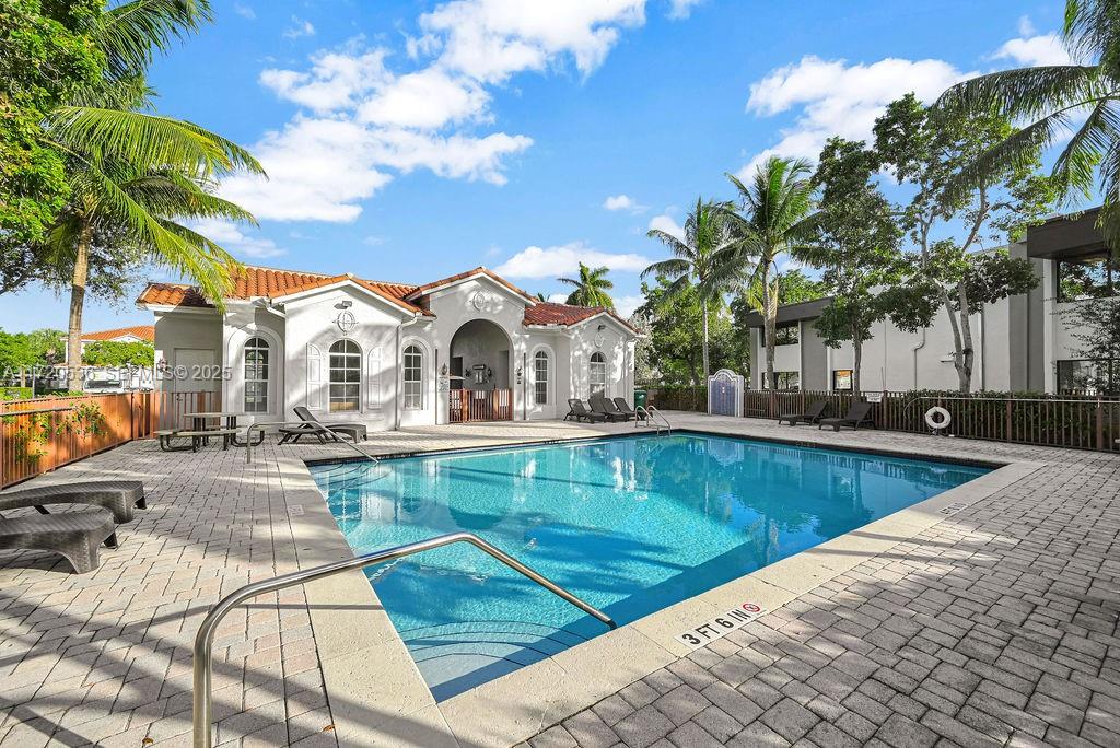 1007 Northeast 208th Street, Unit 1007 Miami, FL 33179 - Photo 33 of 68 a view of a swimming pool with a lounge chairs