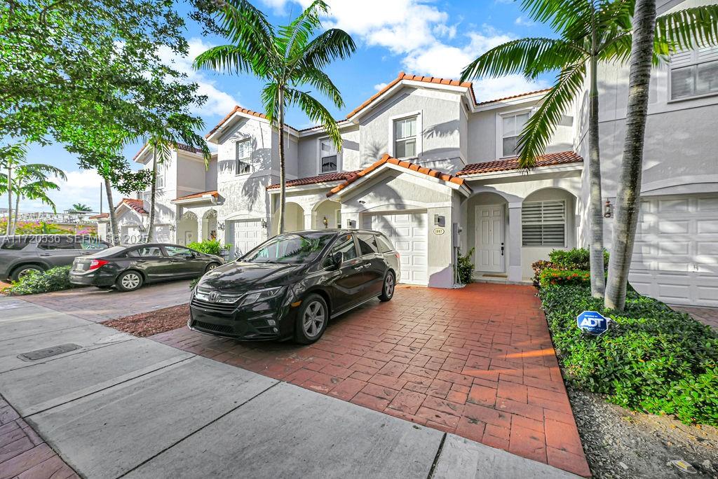 1007 Northeast 208th Street, Unit 1007 Miami, FL 33179 - Photo 36 of 68 a car parked in front of a house